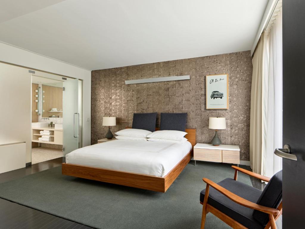 a bedroom with a large bed and two chairs at Smyth Tribeca in New York