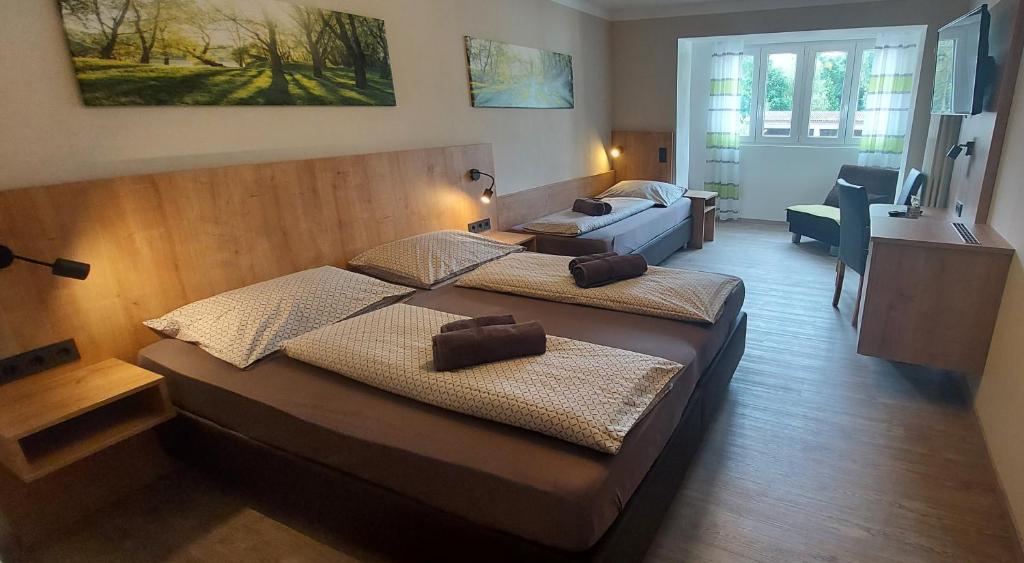 1 dormitorio con 2 camas y sala de estar en Pension DELAGERA en Großmehring