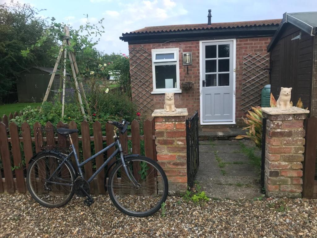 ein Fahrrad, das vor einem Haus geparkt ist in der Unterkunft The Homestead, Cliff-en-Howe Rd, Pott Row, Kings Lynn in Grimston