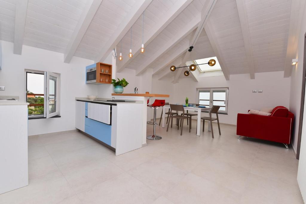 a kitchen and living room with a table and chairs at SoleLuna Agerola in Agerola