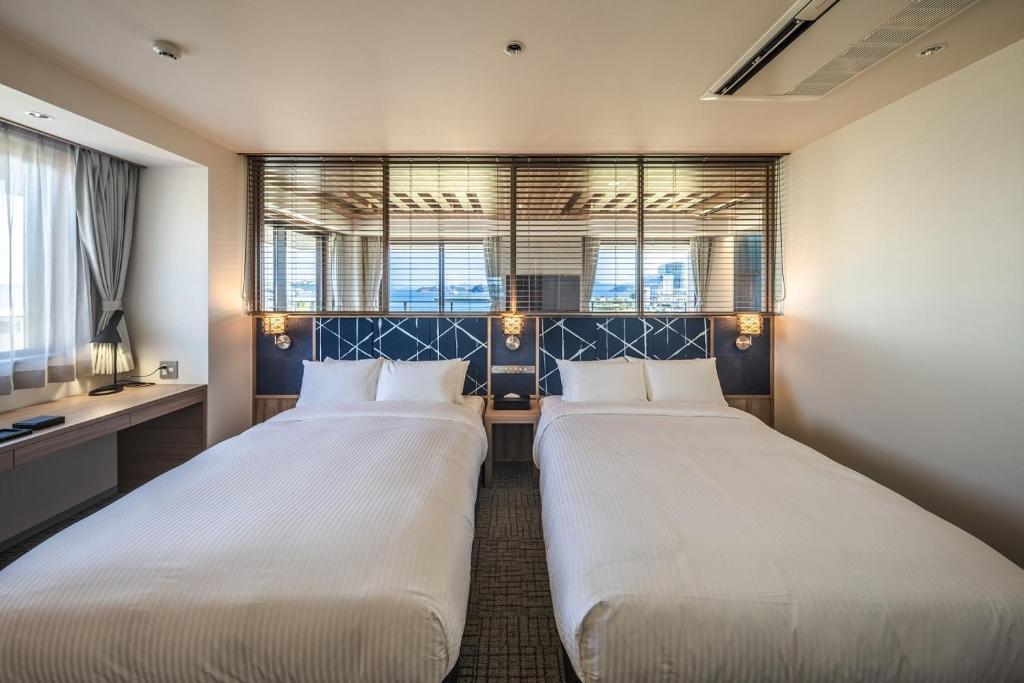 Postel nebo postele na pokoji v ubytování UNO HOTEL