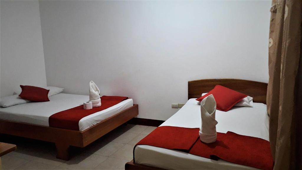 Postel nebo postele na pokoji v ubytování Hostal El Pinzón
