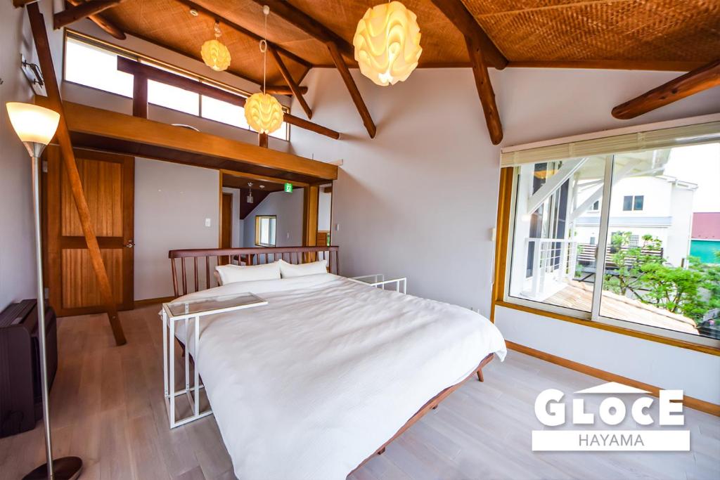 Postel nebo postele na pokoji v ubytování GLOCE 葉山 Ocean View House 都心から1時間 湘南の絶景を独り占めペットok 出張BBQ有り