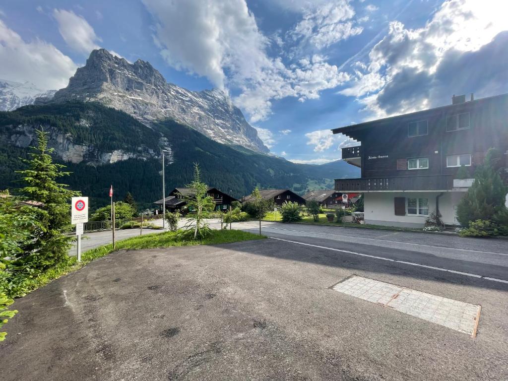 an empty road in front of a mountain at Almis Sunna in Grindelwald