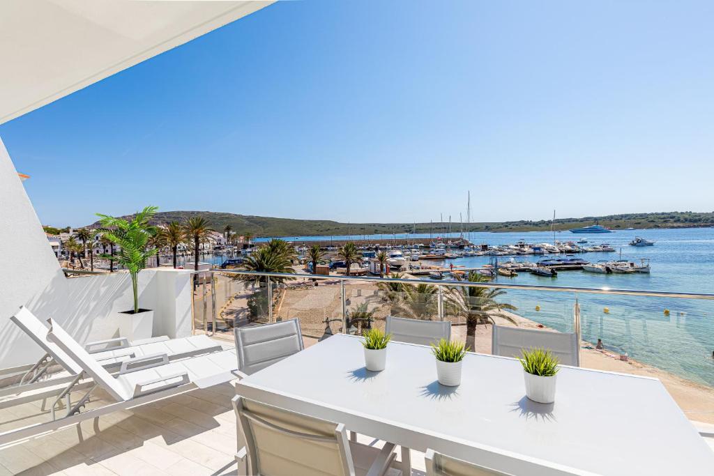 a balcony with a table and chairs and a view of the water at MEVAMAR in Fornells