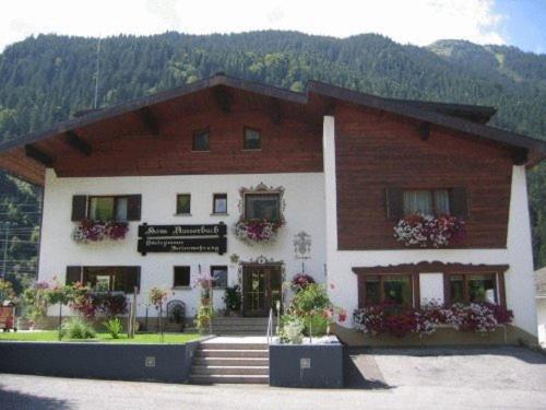 un gran edificio con una escalera delante en Haus Ausserbach, en Gaschurn