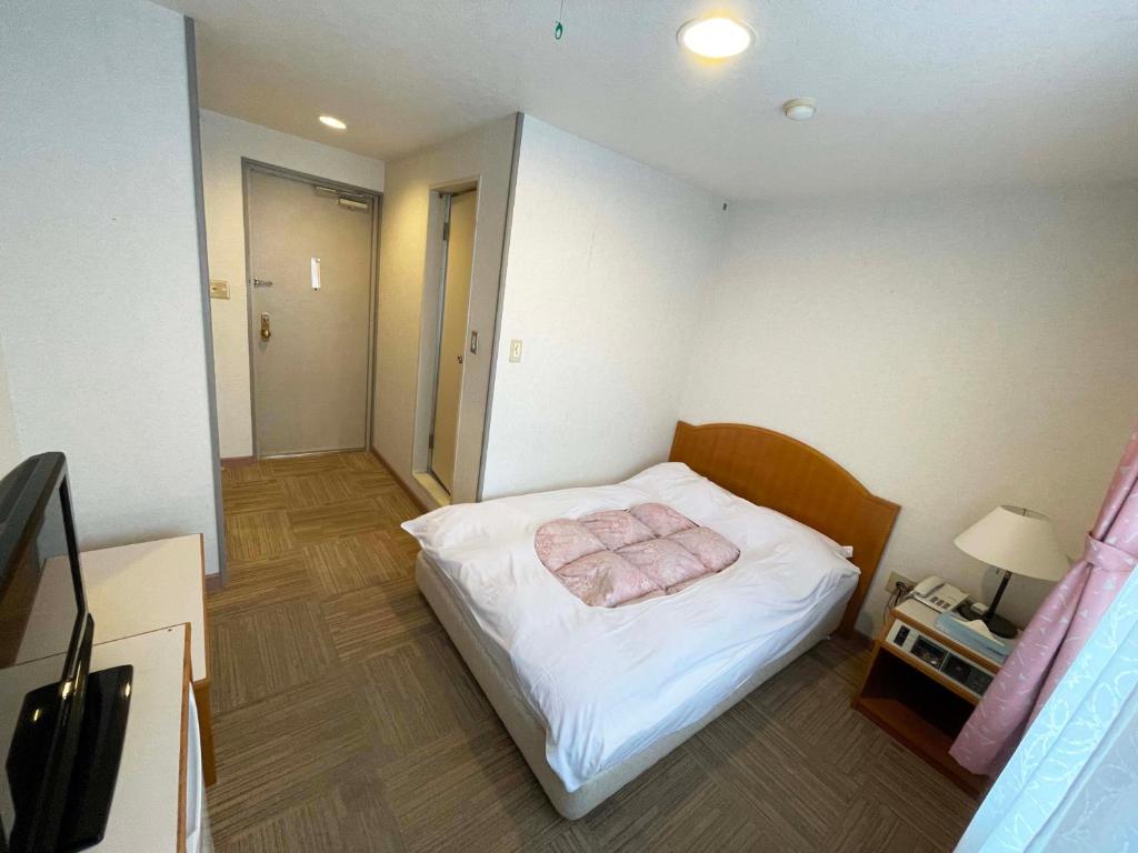 Postel nebo postele na pokoji v ubytování Hotel Ginsui