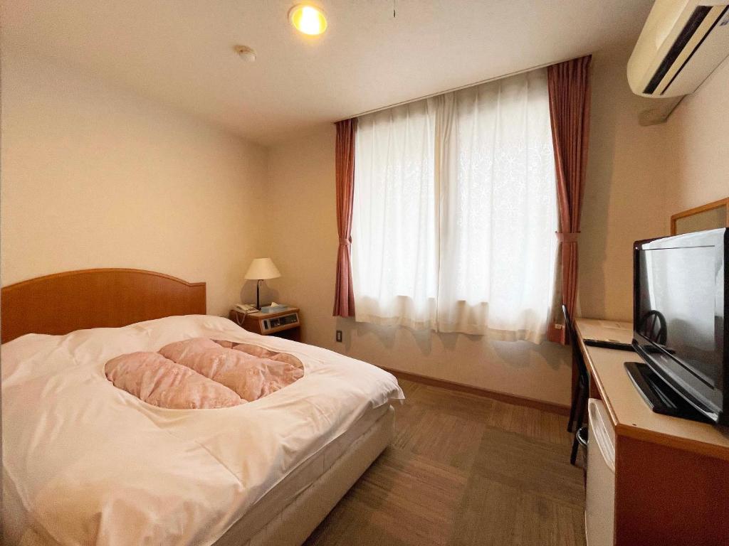 Postel nebo postele na pokoji v ubytování Hotel Ginsui
