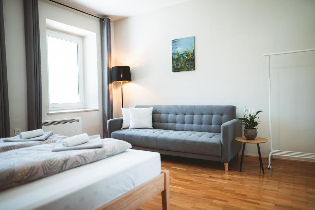 a living room with a couch and a bed at Gorska Roža in Log pod Mangartom