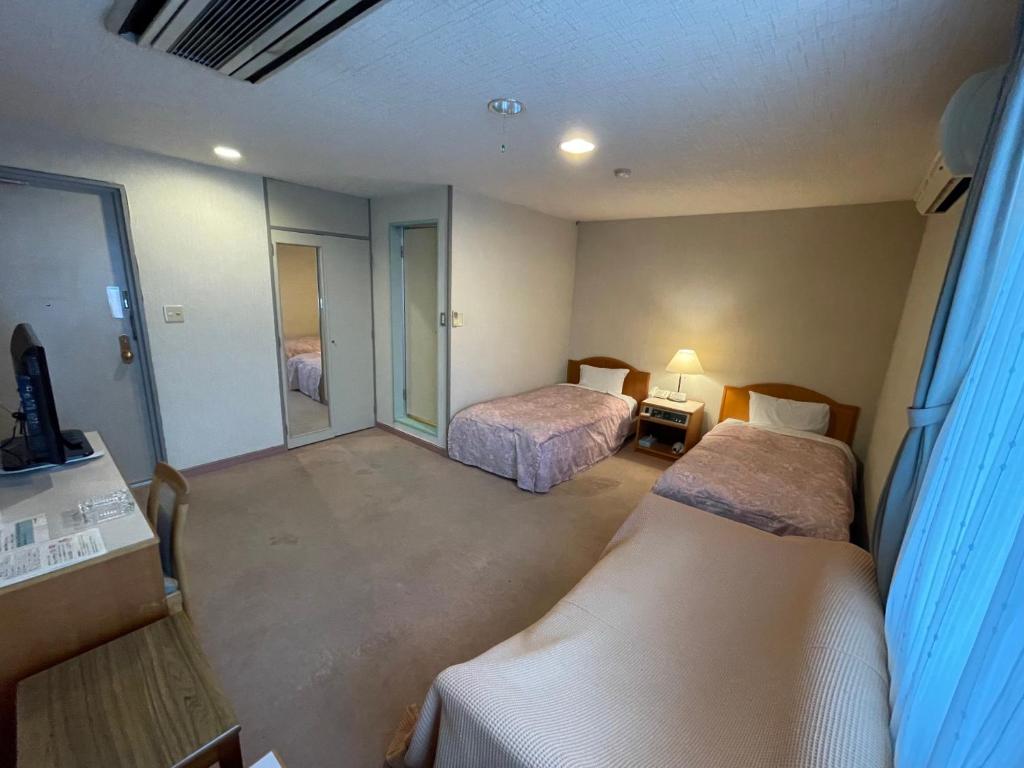 Postel nebo postele na pokoji v ubytování Hotel Ginsui