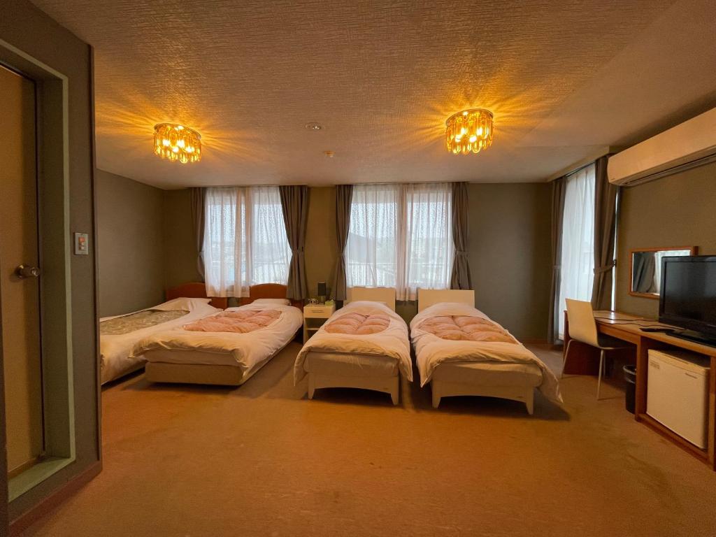 Postel nebo postele na pokoji v ubytování Hotel Ginsui