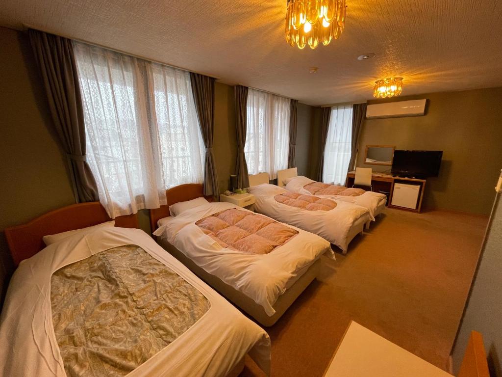 Postel nebo postele na pokoji v ubytování Hotel Ginsui