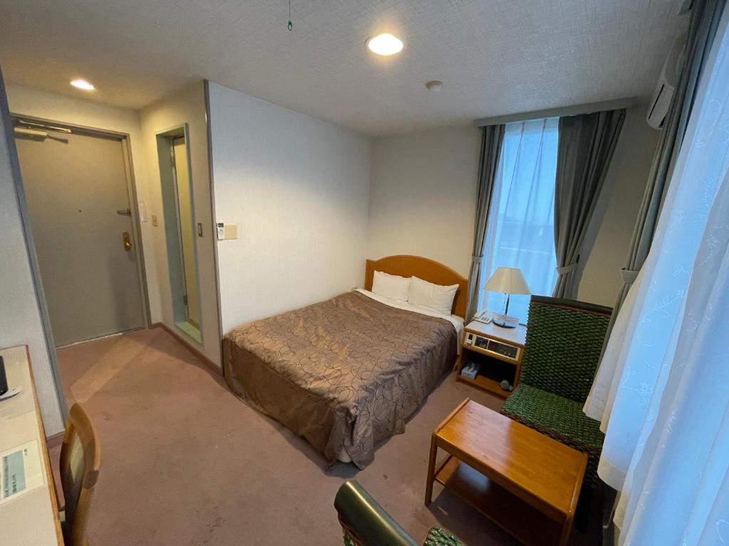 Postel nebo postele na pokoji v ubytování Hotel Ginsui
