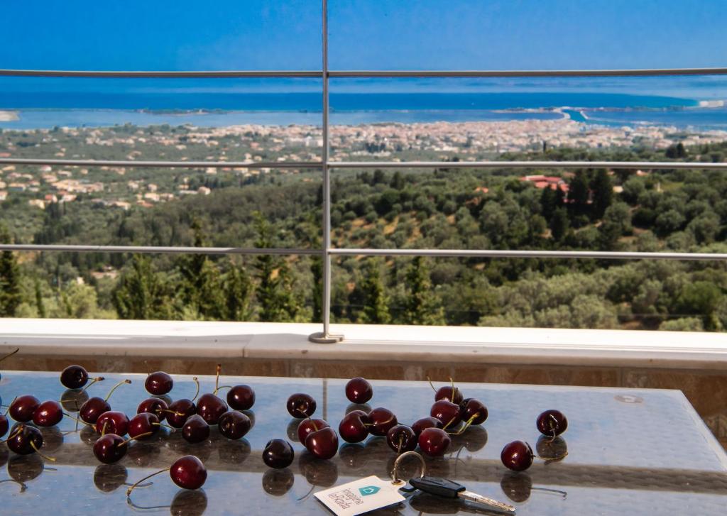 a bunch of cherries on a table in front of a window at Vista Del Diamante Apartments in Apolpaina