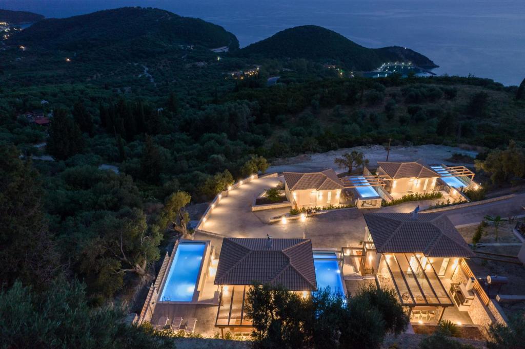 an aerial view of a villa with a pool at night at Horizon Ionian Villas in Perdika