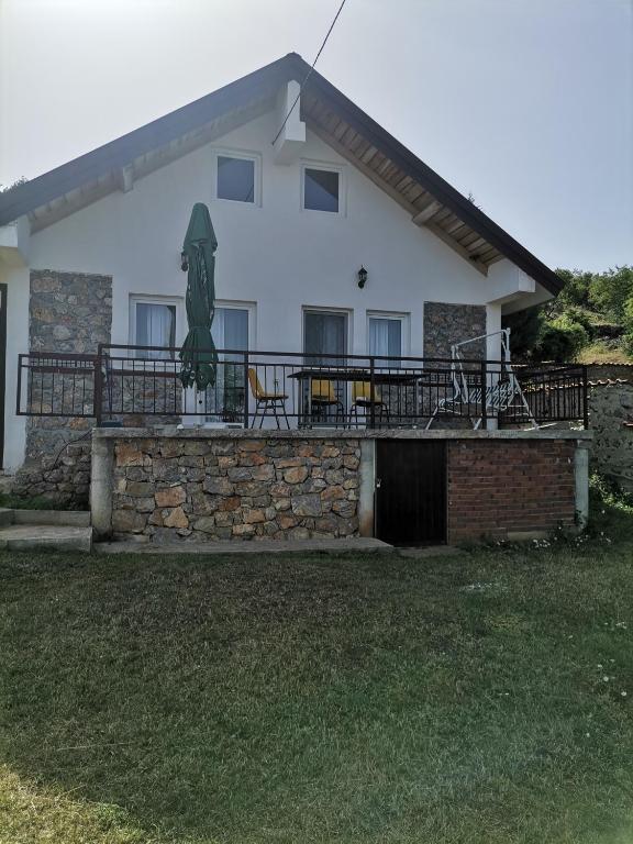 a house with a stone wall and a patio at Villa Sofia in Ohrid