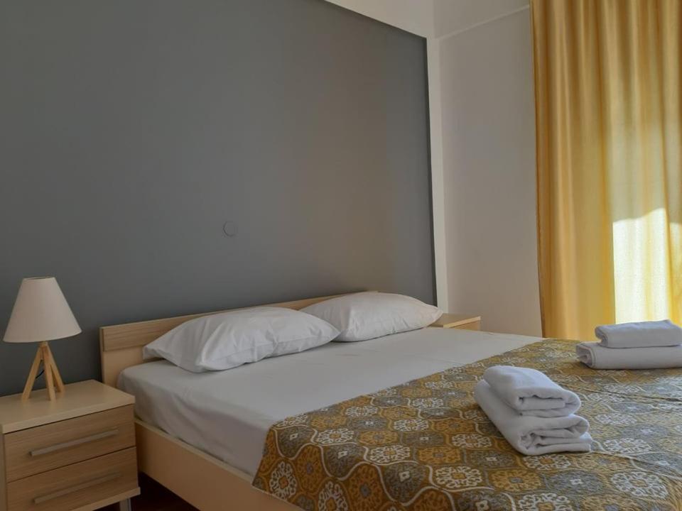 a bedroom with a bed with towels on it at Sunny Lakeside Apartment in Ohrid