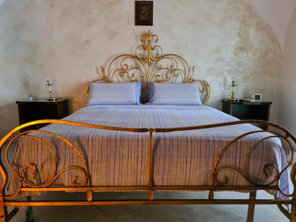 a large bed with a wooden frame in a bedroom at Civico 30 in Naples