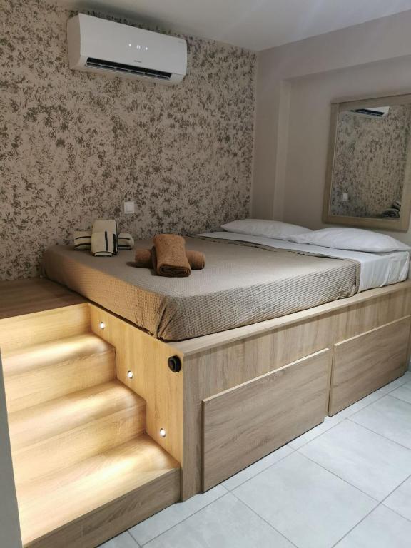 a bedroom with a large bed with wooden drawers at Old Town Euphoria Suite in Kos