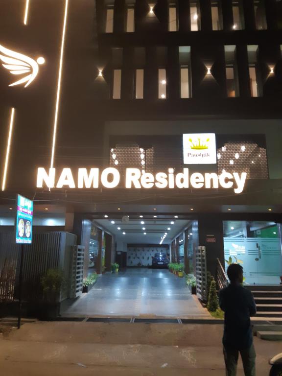 a man standing in front of a nomo headquarters at Hotel Namo Residency in Vijayawāda