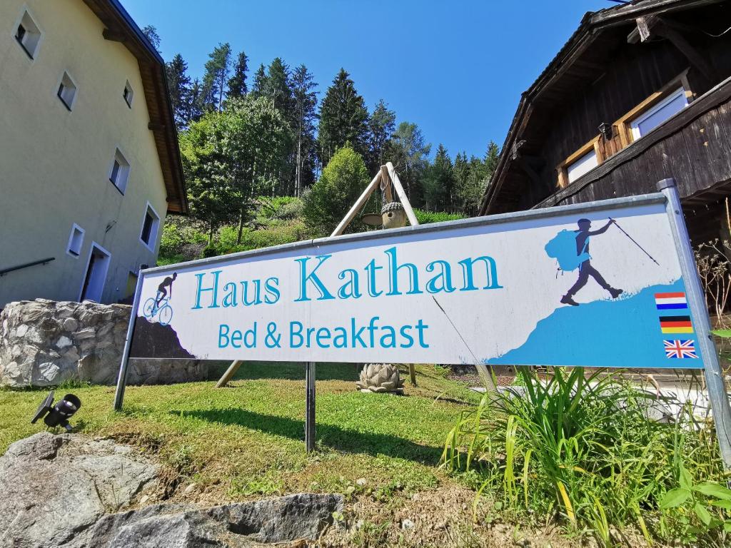 a sign for hawkins kathryn bed and breakfast at Haus Kathan in Kamering