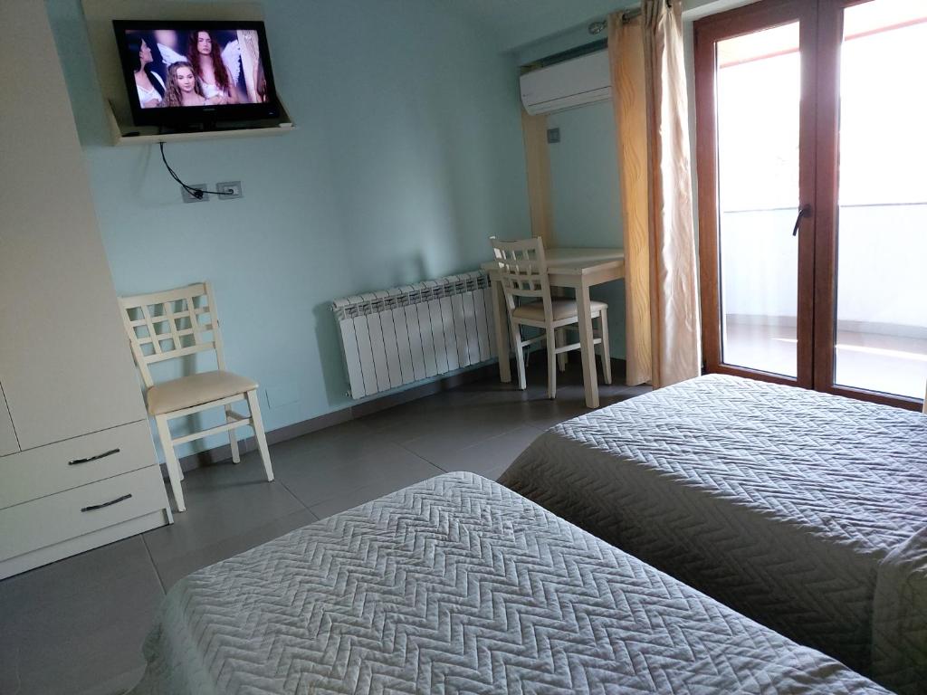 Postel nebo postele na pokoji v ubytování Hotel Piazza