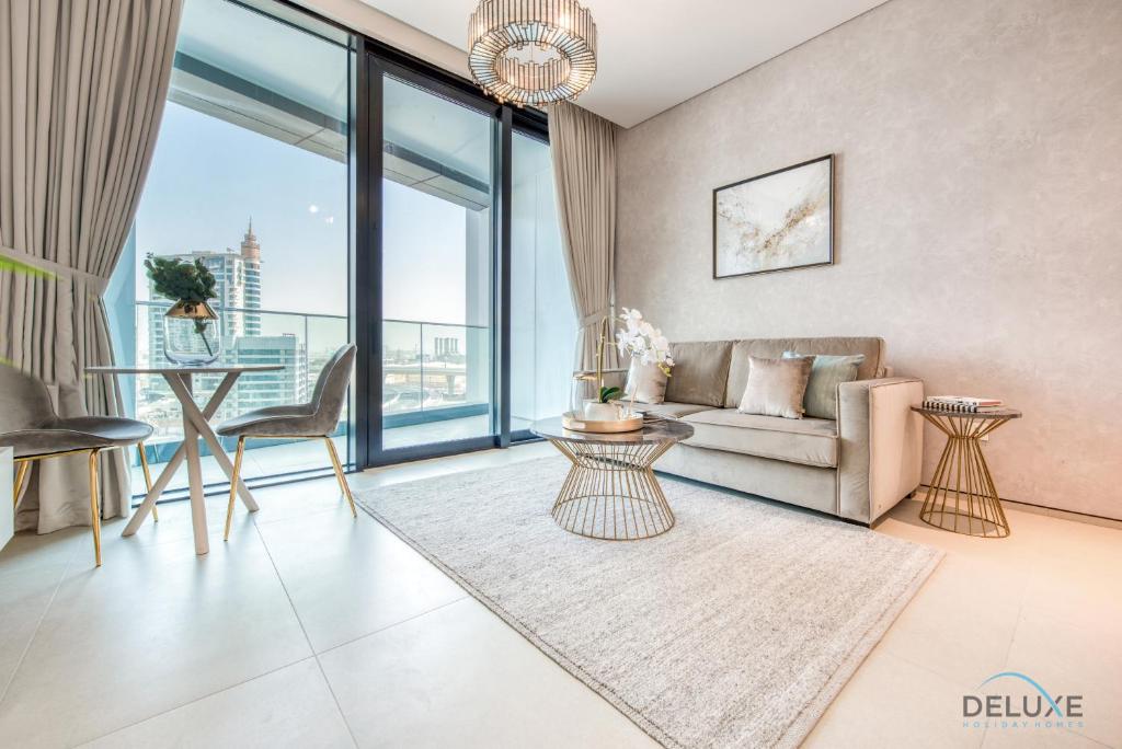 Exquisite 1BR at The Address Residences in JBR by Deluxe Holiday Homes في دبي: غرفة معيشة مع أريكة وطاولة