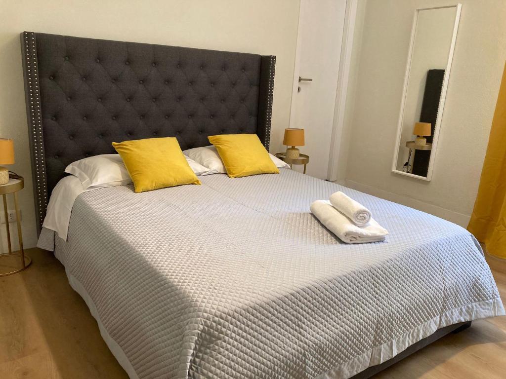 a bedroom with a large bed with two towels on it at FAIROME Guest House in Rome