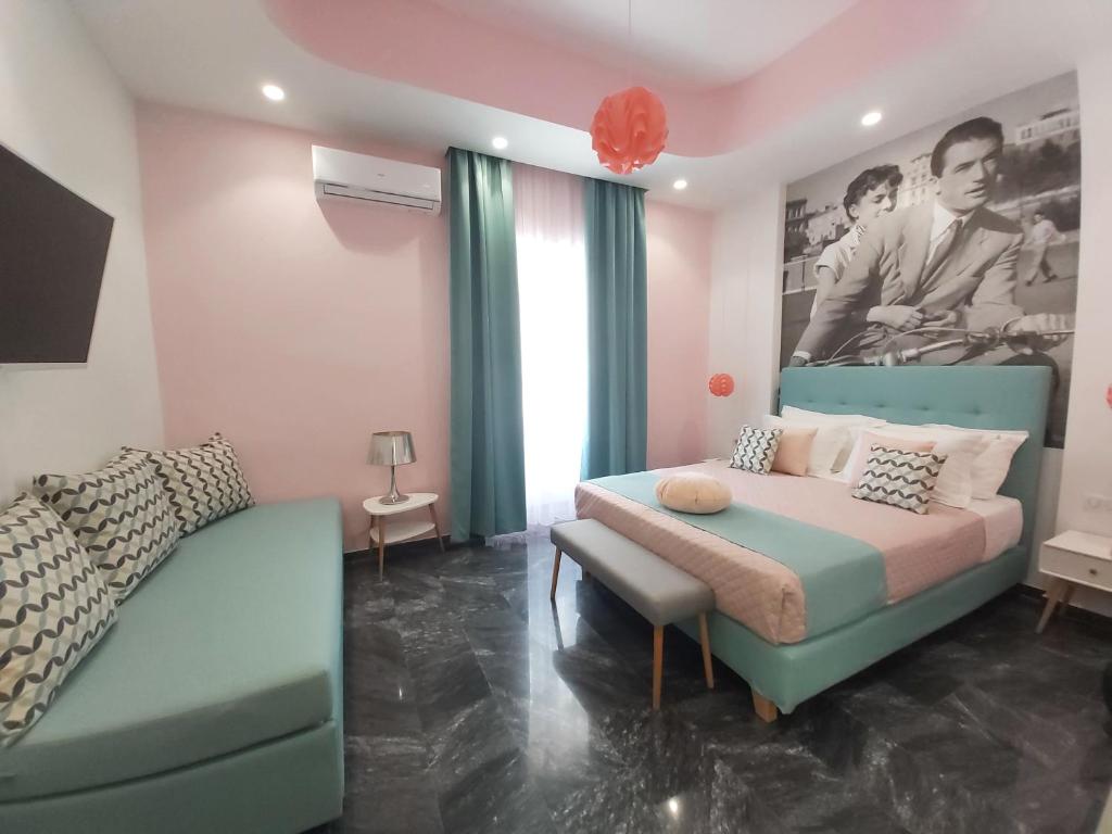 a bedroom with a bed and a couch and a chair at Nostalgia Retro Suites in Naxos Chora