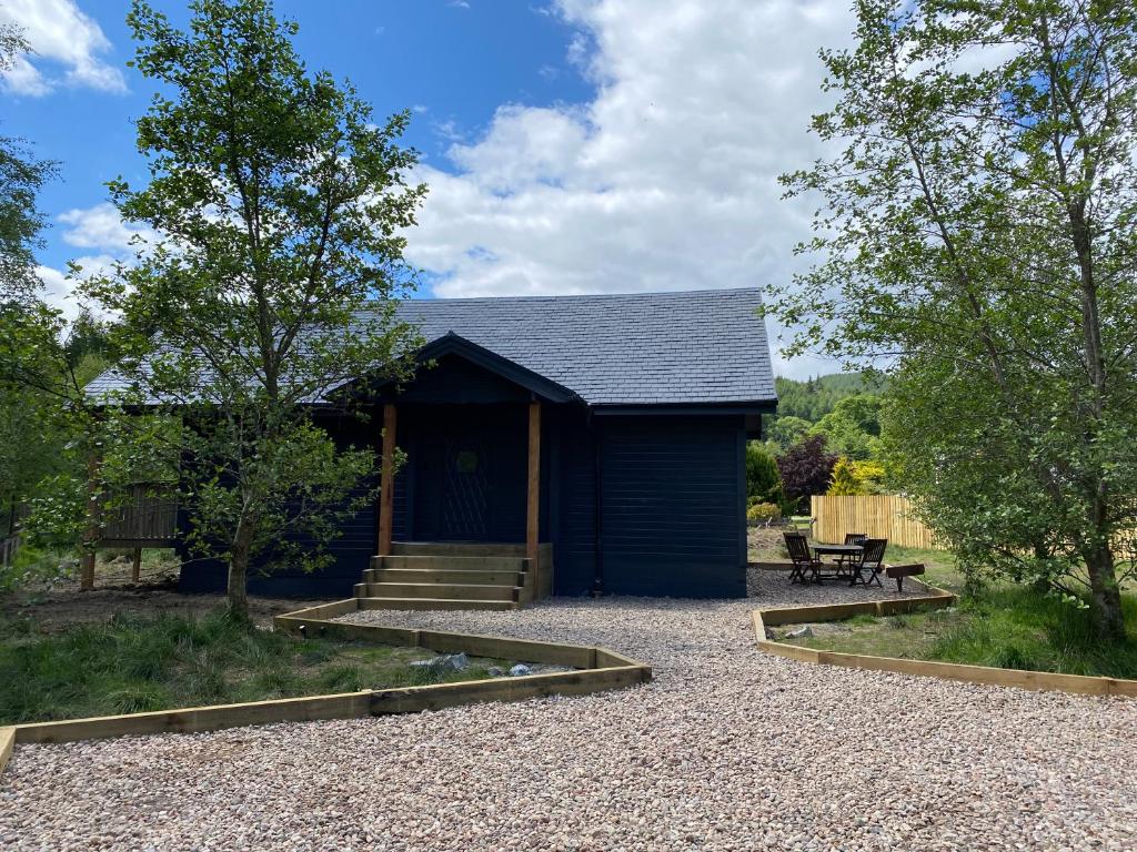 a blue shed with a bench in front of it at Hatton Lodge in Dunkeld