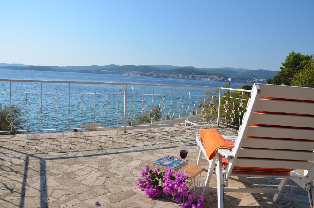 a chair and a table and a view of the water at Apartments Šestanović in Orebić