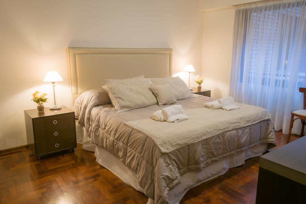 a bedroom with a large bed with two pillows on it at Departamento del Boulevard in Cordoba