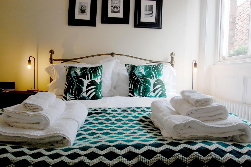 a bedroom with a bed with towels on it at Joseph's Loft in York