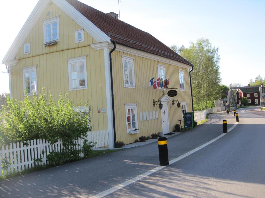 a yellow building on the side of a street at Gula Huset in Storebro