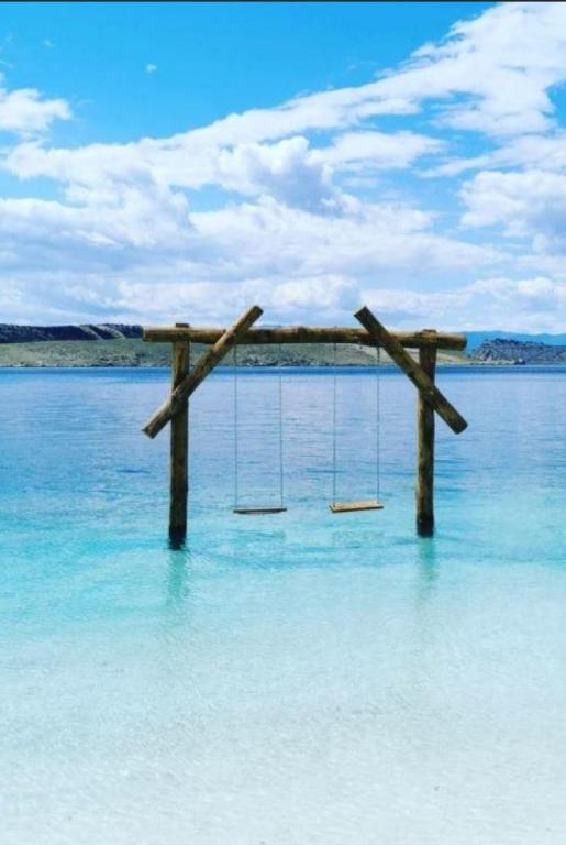 a swing in the middle of a body of water at Apartmani Božica in Jadranovo