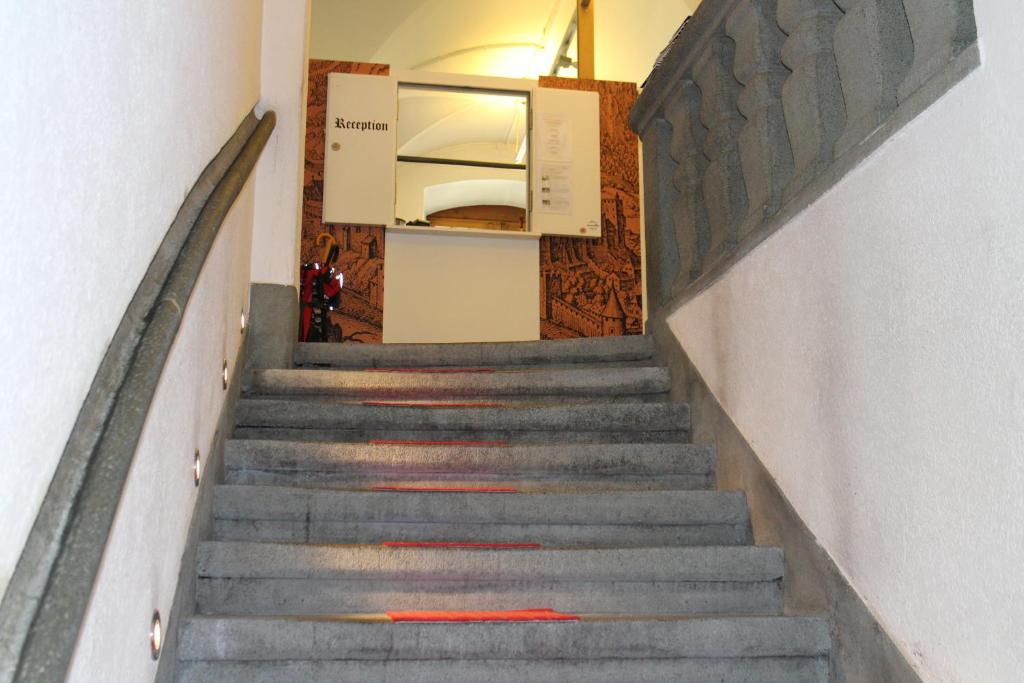 a staircase in a building with red paint on it at Zunfthaus zur Rebleuten in Chur