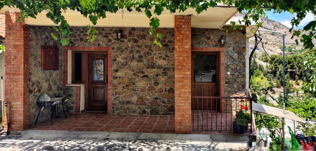a brick house with a door and a porch at Το Σπίτι του Προκόπη in Nicosia