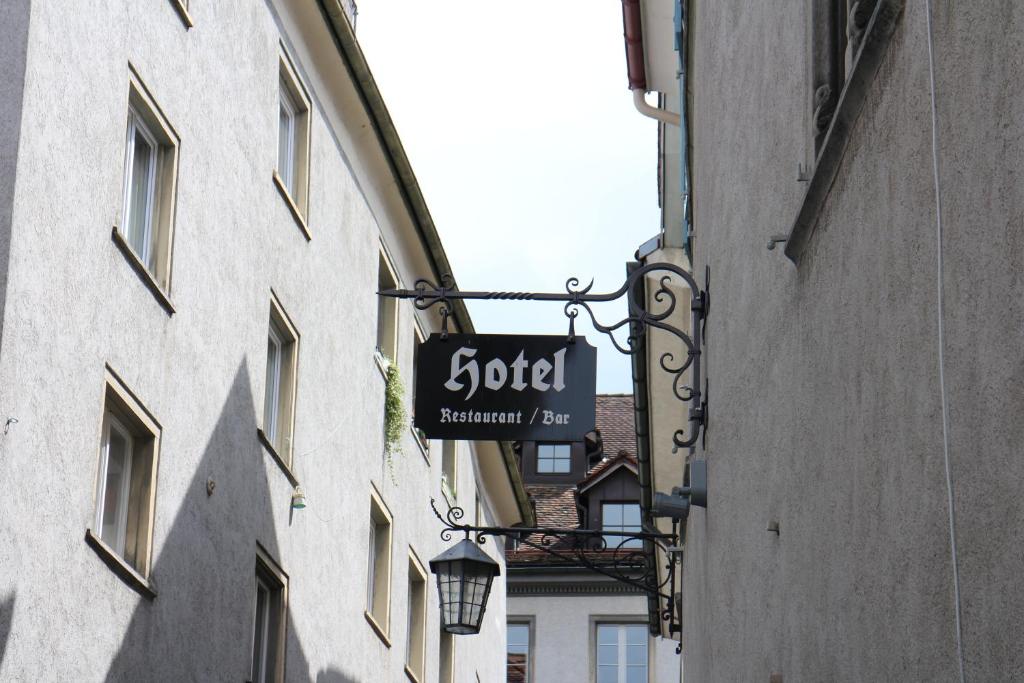 a sign for a hotel hanging on the side of a building at Zunfthaus zur Rebleuten in Chur