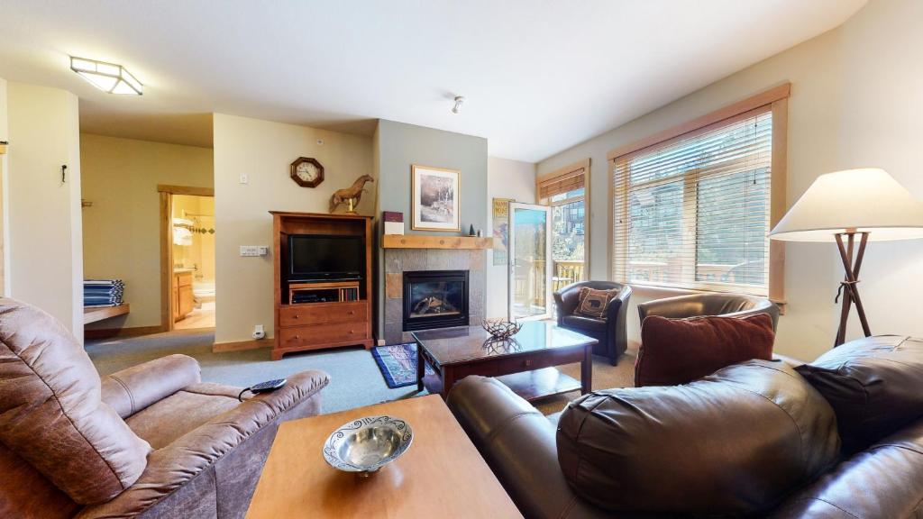 a living room with leather furniture and a fireplace at Sunstone #322 condo in Mammoth Lakes