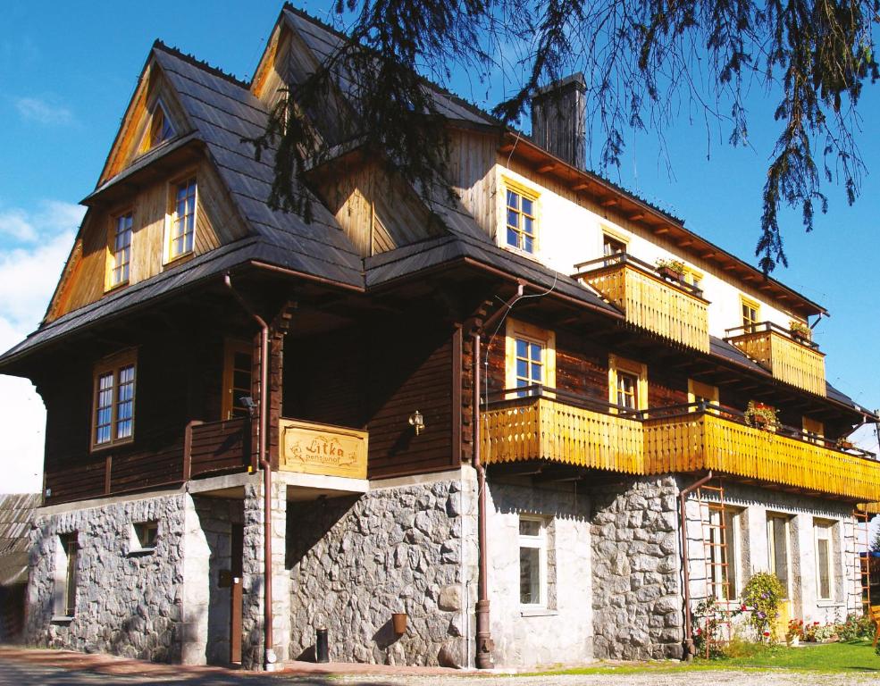 Una gran casa de madera con balcones en la parte superior. en Willa Litka, en Bukowina Tatrzańska