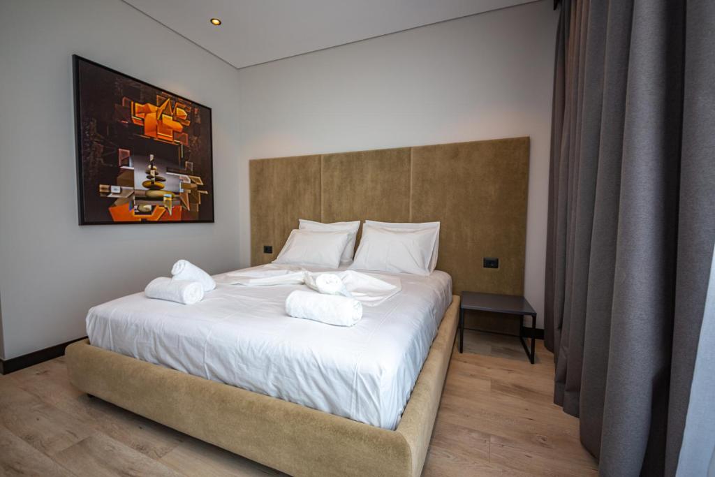 a bedroom with a bed with towels on it at Apart-Hotel Lili2 in Sarandë