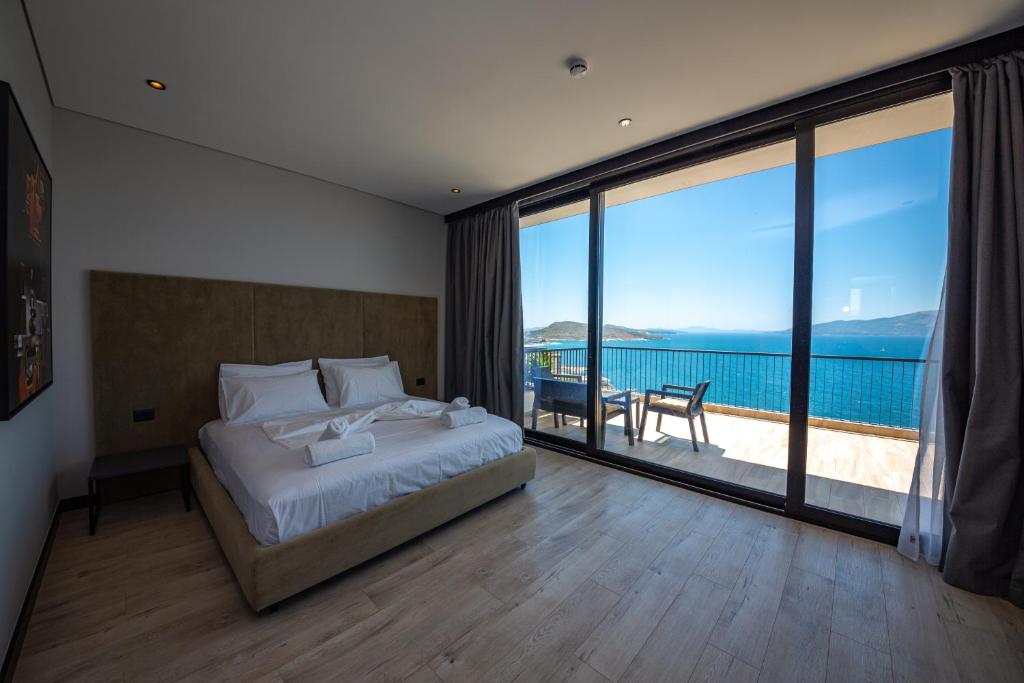 a bedroom with a bed and a view of the ocean at Apart-Hotel Lili2 in Sarandë