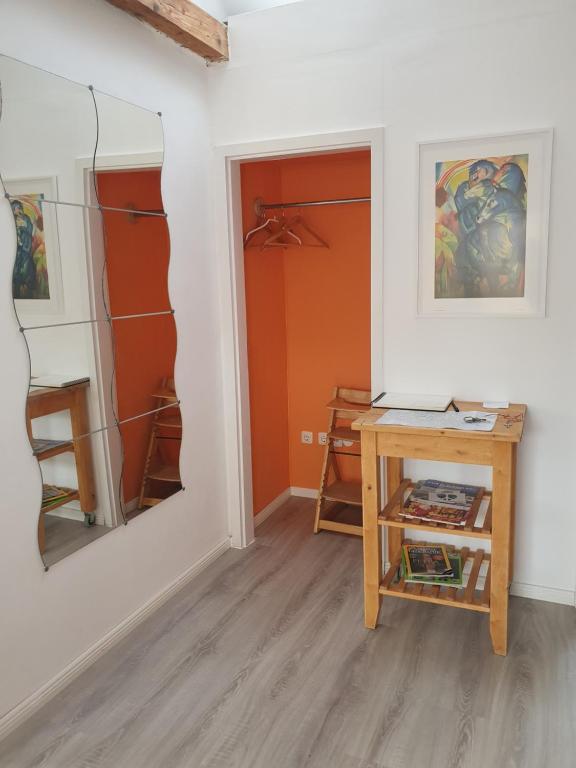 a room with a table and a painting on the wall at Helle, moderne Altbauwohnung in Zentrumsnähe in Osnabrück