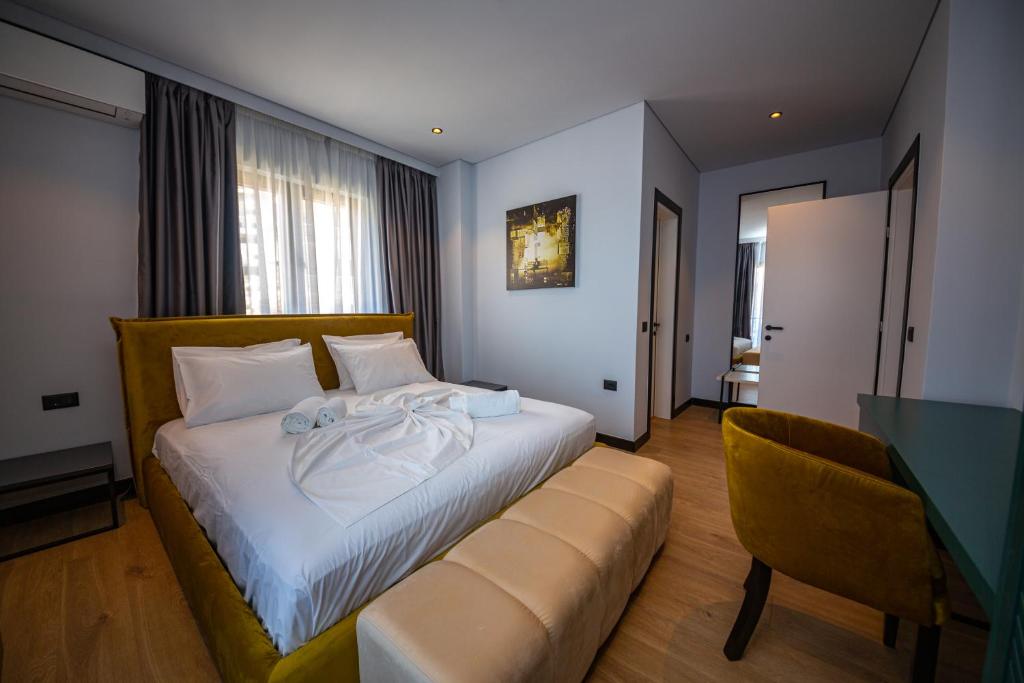 a hotel room with a bed and a couch at Apart-Hotel Lili2 in Sarandë
