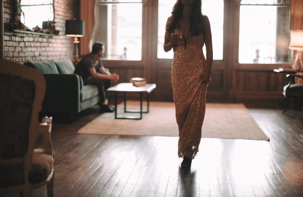 a woman in a sequin dress standing in a living room at The Grand Hotel in Hogansville
