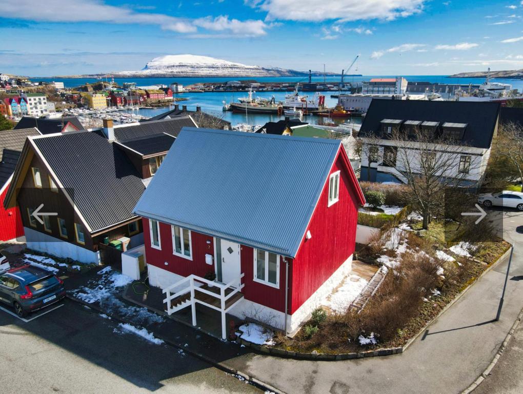 an aerial view of a red house with a blue roof at Luxurious House in Downtown Tórshavn in Tórshavn