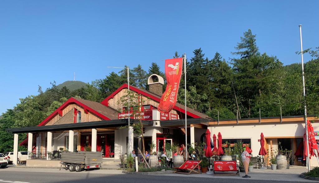 a building with red flags in front of it at Alpin Rose Appartement in Semmering