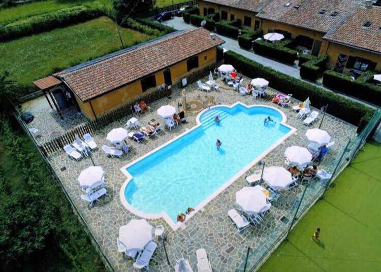 an overhead view of a swimming pool with chairs and umbrellas at Chalet San Massimo in San Massimo