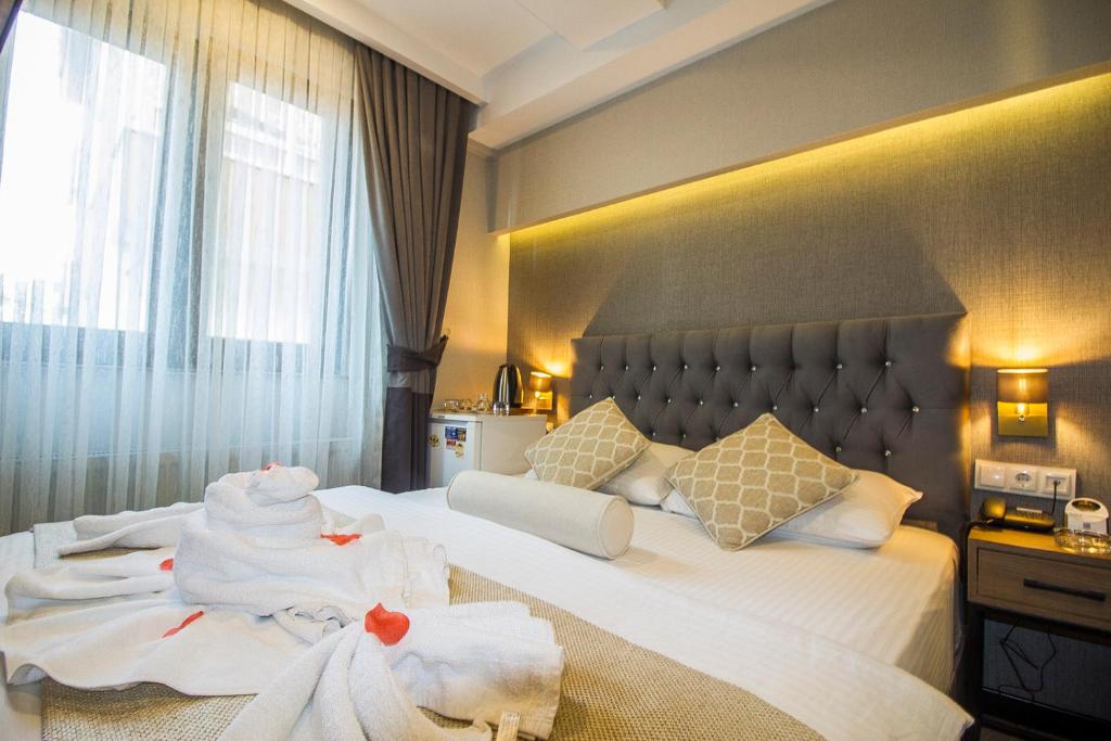 une chambre d'hôtel avec un lit et des serviettes. dans l'établissement Nostalji Hotel, à Avcılar
