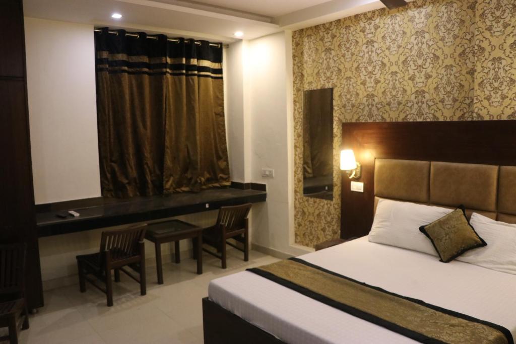 a hotel room with a bed and a desk at Hotel The Black Gold in Chandīgarh